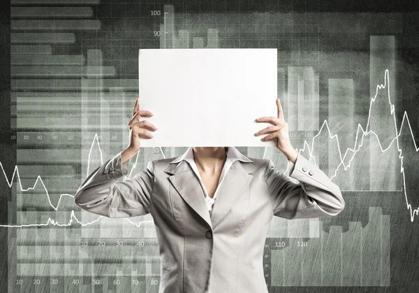 Businesswoman hiding her face behind paper — Stock Photo, Image