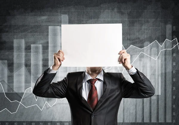 Businessman hiding his face behind paper — Stock Photo, Image