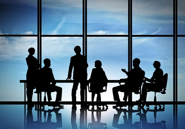 Businessteam sitting round table — Stock Photo, Image