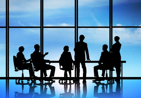 Businessteam sitting round table — Stock Photo, Image