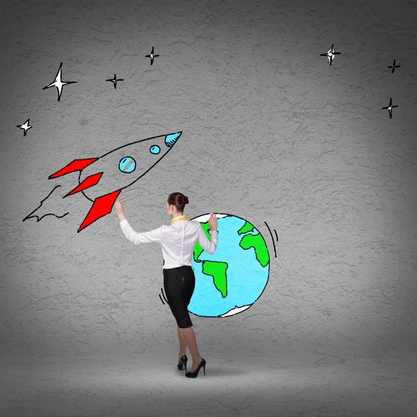 Businesswoman drawing rocket — Stock Photo, Image