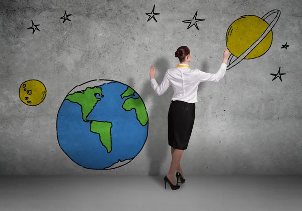 Businesswoman presenting drawn planet — Stock Photo, Image