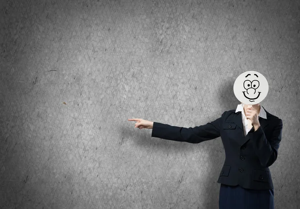 Businesswoman hiding face behind mask — Stock Photo, Image