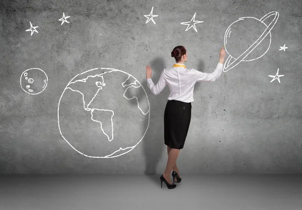 Businesswoman presenting drawn planet — Stock Photo, Image