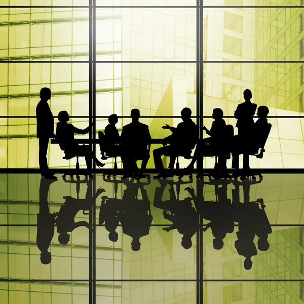 Businessteam sitting round table — Stock Photo, Image