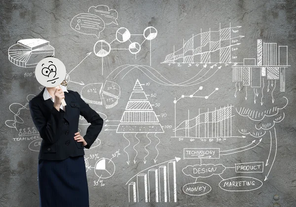 Businesswoman hiding face behind mask — Stock Photo, Image