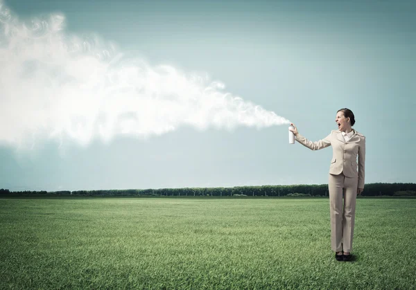 Businesswoman using spray — Stock Photo, Image