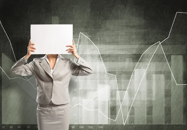 Businesswoman hiding her face behind paper — Stock Photo, Image