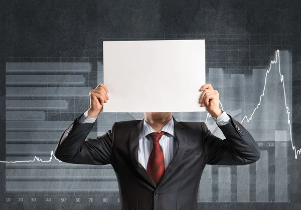 Businessman hiding his face behind paper — Stock Photo, Image