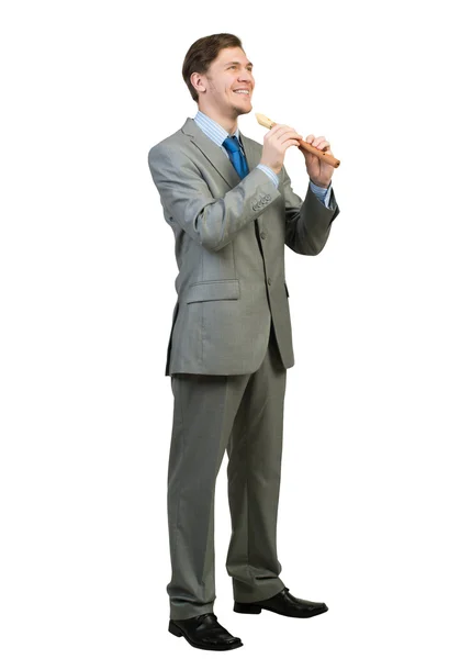 Businessman plays fife — Stock Photo, Image