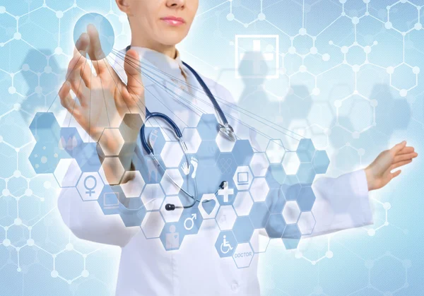 Young female doctor touching icon — Stock Photo, Image