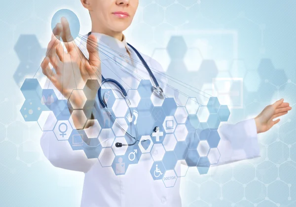 Young female doctor touching icon — Stock Photo, Image
