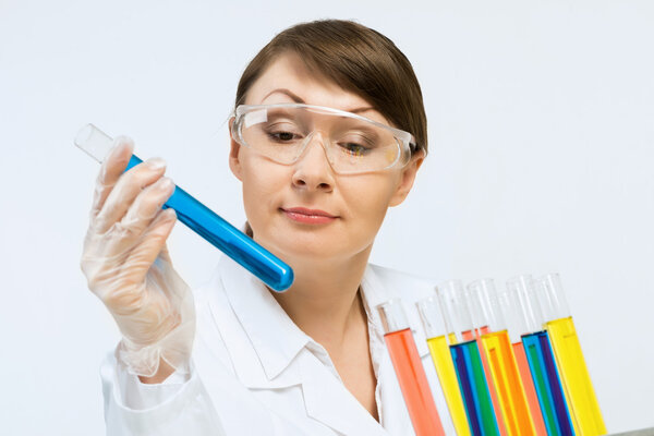 Attractive female scientist making tests