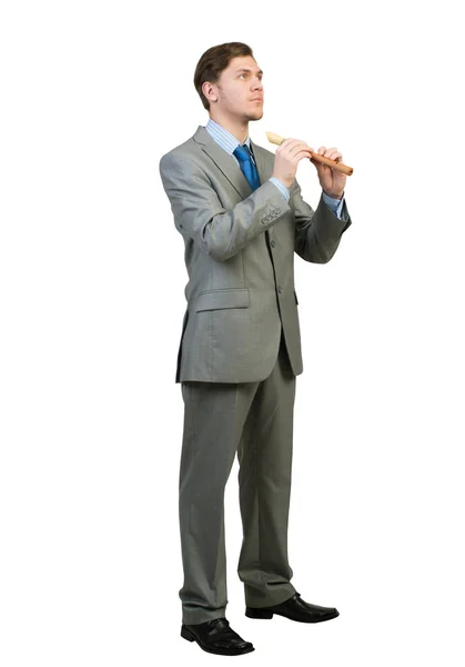 Businessman plays fife — Stock Photo, Image