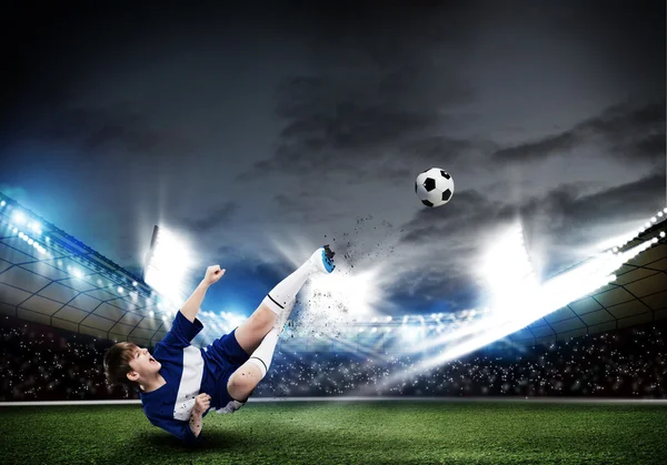 Kid boy kicking soccer ball — Stock Photo, Image