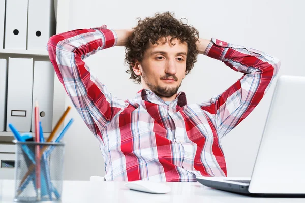 Jovem homem relaxado no escritório — Fotografia de Stock