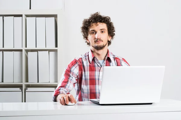 Man working in office with notebook