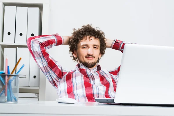 Young relaxed man  in his office