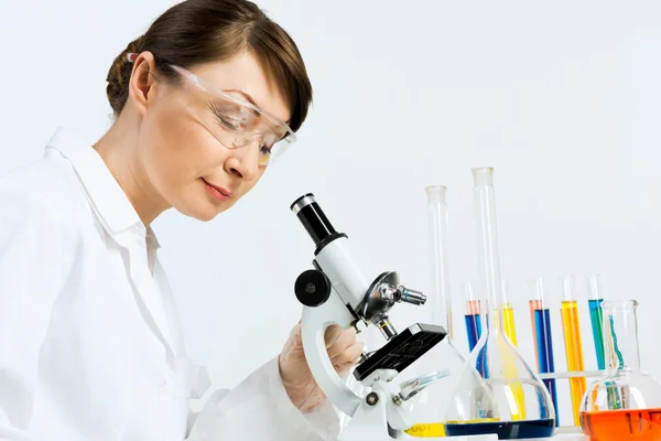 Scientist looking at the microscope — Stock Photo, Image