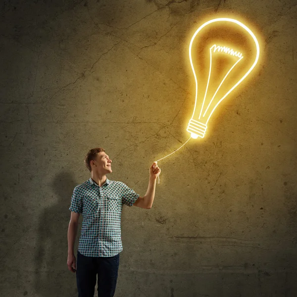 Young man and electrical bulb — Stock Photo, Image