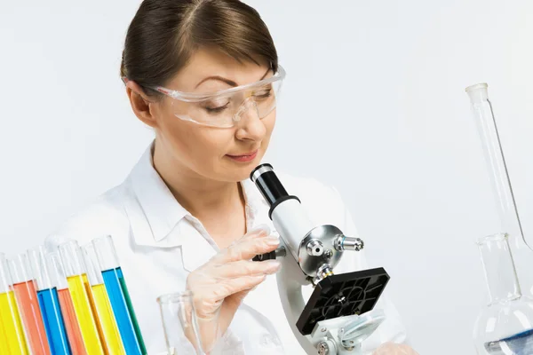 Femme scientifique regardant le microscope — Photo