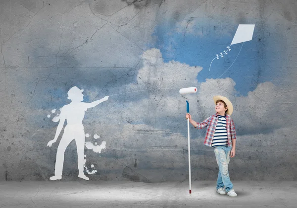 Boy painting wall with roller — Stock Photo, Image