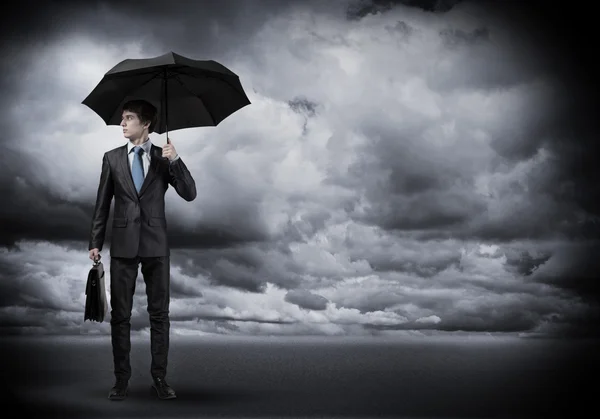 Young Businessman with umbrella Royalty Free Stock Photos