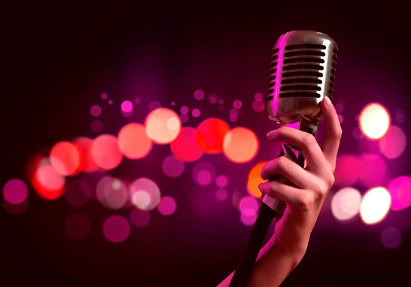 Female hand with microphone — Stock Photo, Image