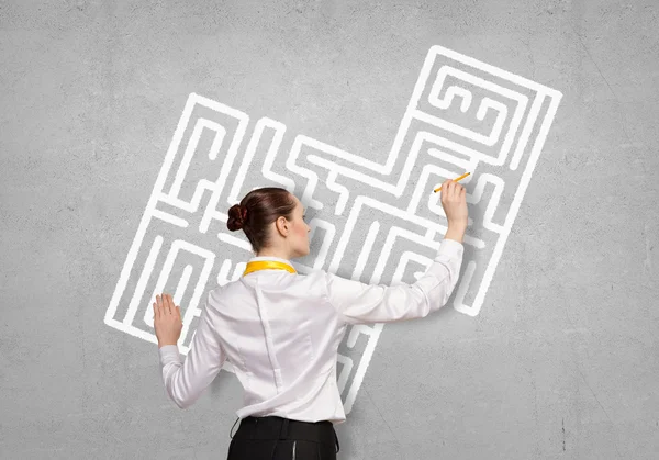 Businesswoman drawing labyrinth — Stock Photo, Image