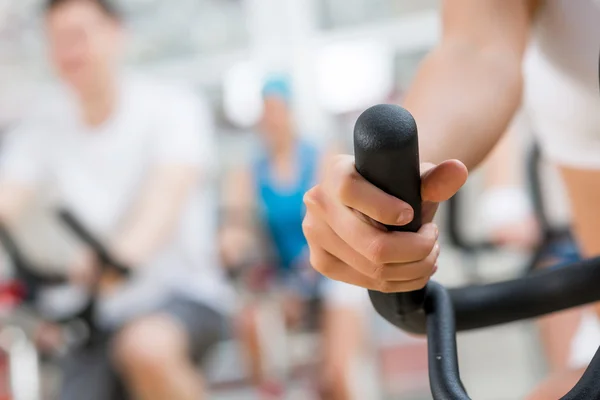 Young people exercising on bikes — Stock Photo, Image