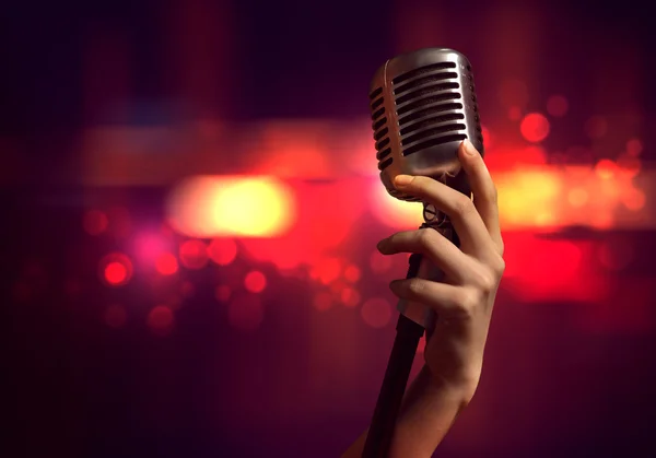 Female hand with microphone — Stock Photo, Image