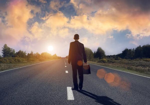 Businessman on asphalt road — Stock Photo, Image