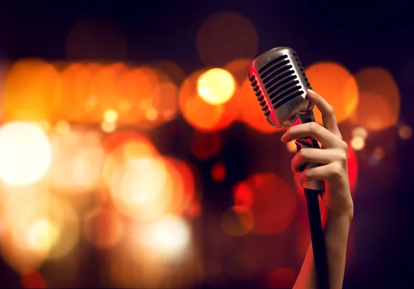 Female hand  holding microphone — Stock Photo, Image