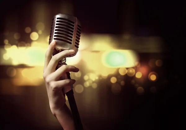 Female hand with microphone — Stock Photo, Image