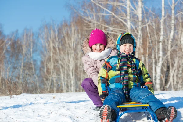 Kids riding sled — Stock Photo, Image