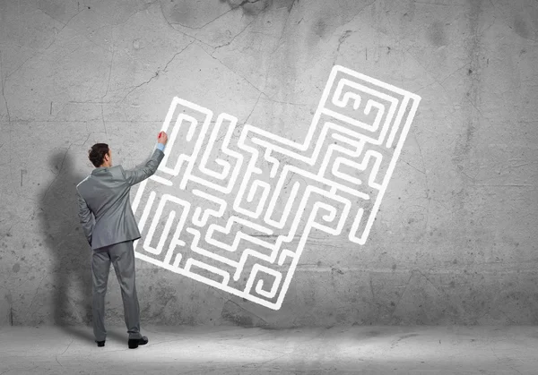 Businessman drawing labyrinth — Stock Photo, Image