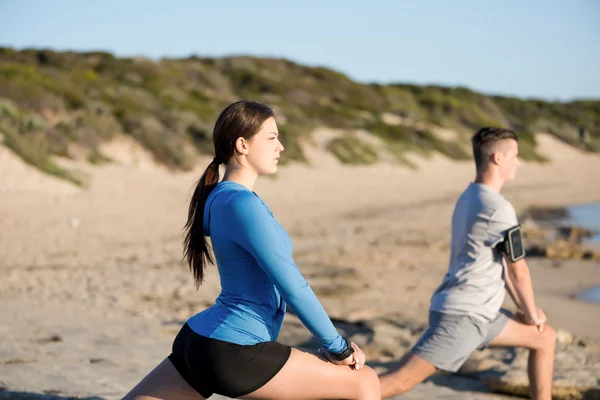 Man and woman stretching — Stock Photo, Image