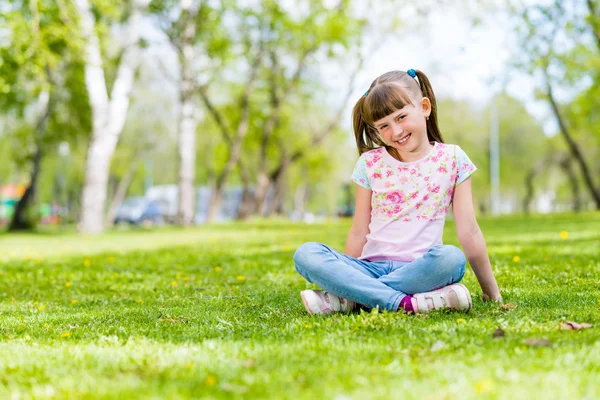 Mädchen sitzt im Park — Stockfoto