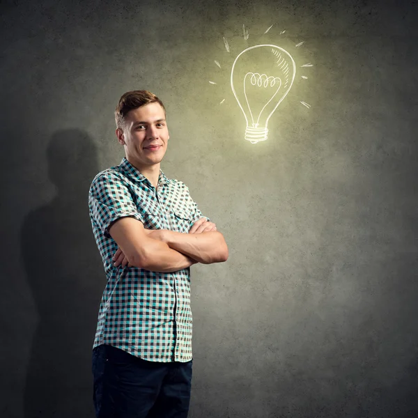 Young man and light bulb — Stock Photo, Image