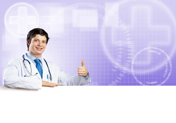 Doctor holding white blank — Stock Photo, Image