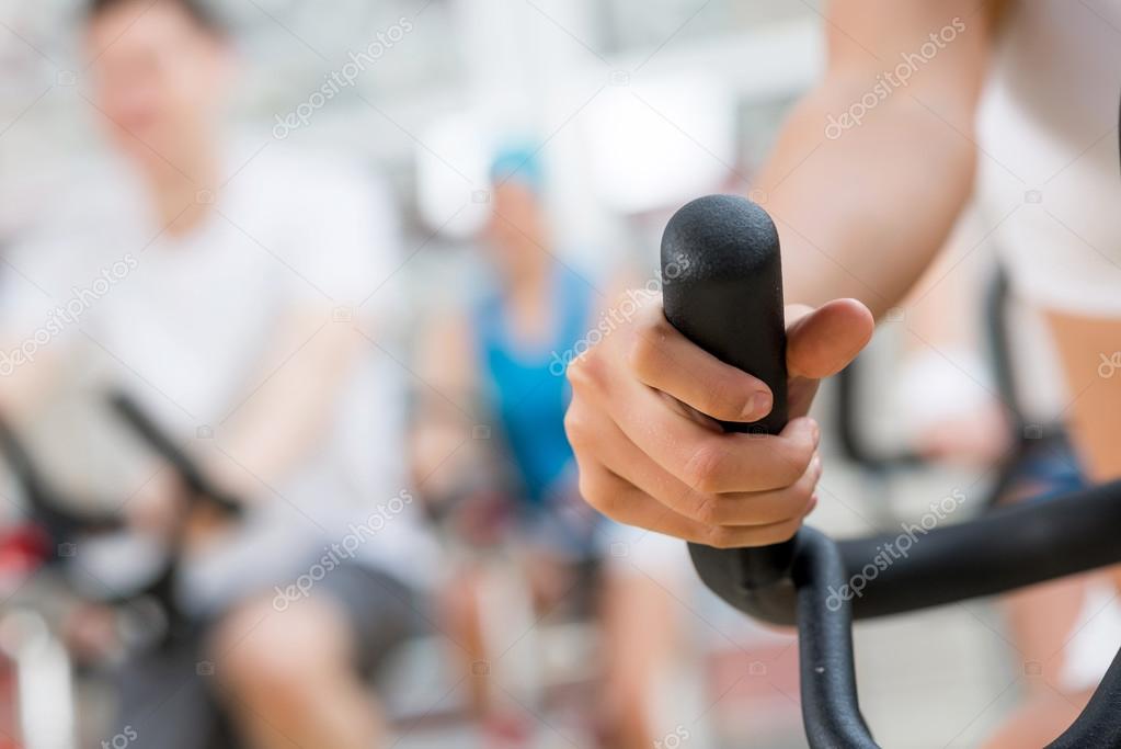 young people exercising on bikes