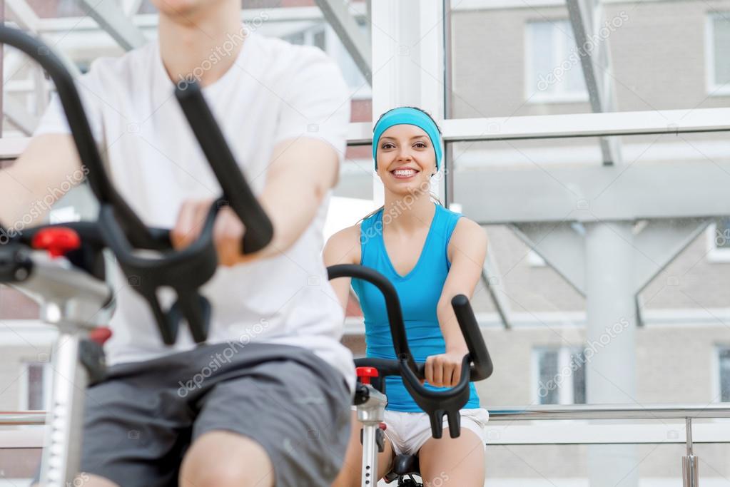 young people exercising on bikes