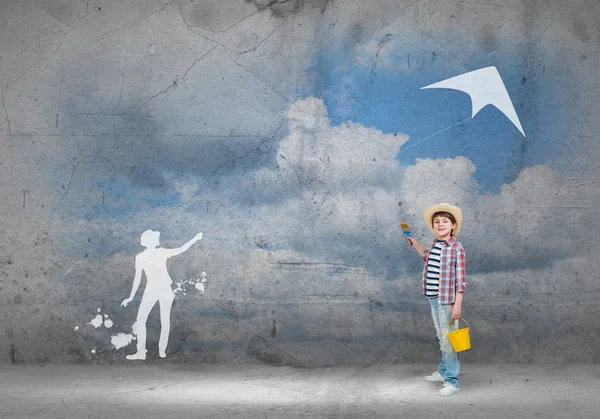 Boy painting wall with brush — Stock Photo, Image