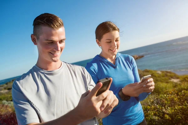 Young couple checking heart rate — Stock Photo, Image