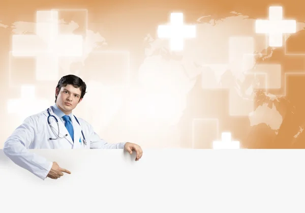 Doctor holding blank banner — Stock Photo, Image