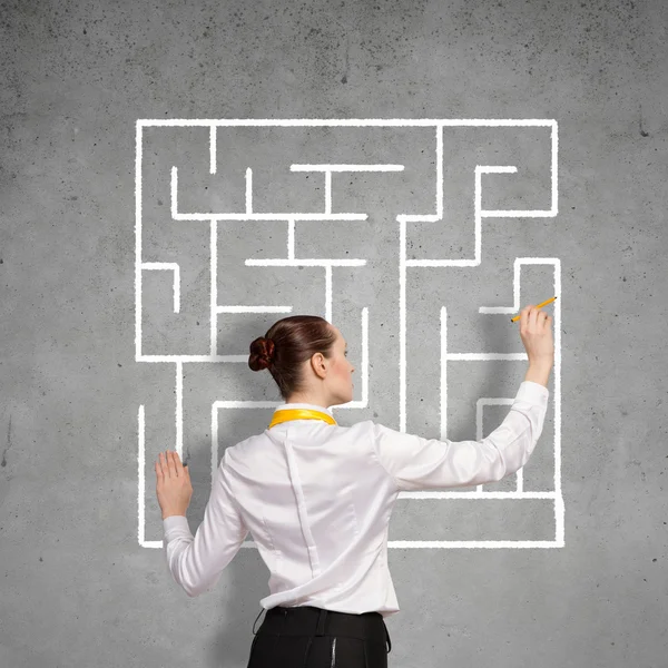 Businesswoman drawing labyrinth — Stock Photo, Image