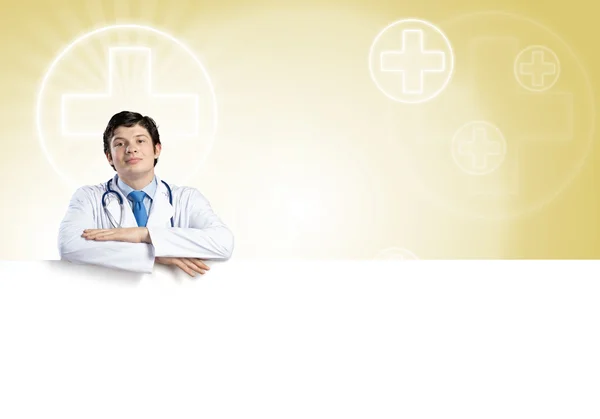 Doctor sosteniendo banner en blanco — Foto de Stock