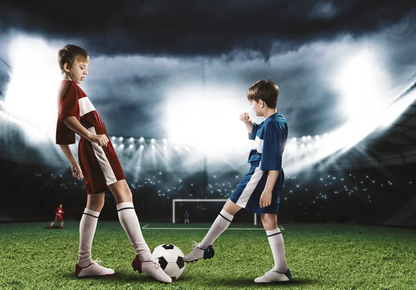 Boys playing football on stadium — Stock Photo, Image