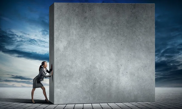 Mujer de negocios moviendo muro de cemento — Foto de Stock