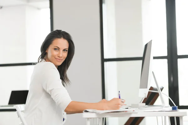 Brünette Frau arbeitet am Computer — Stockfoto